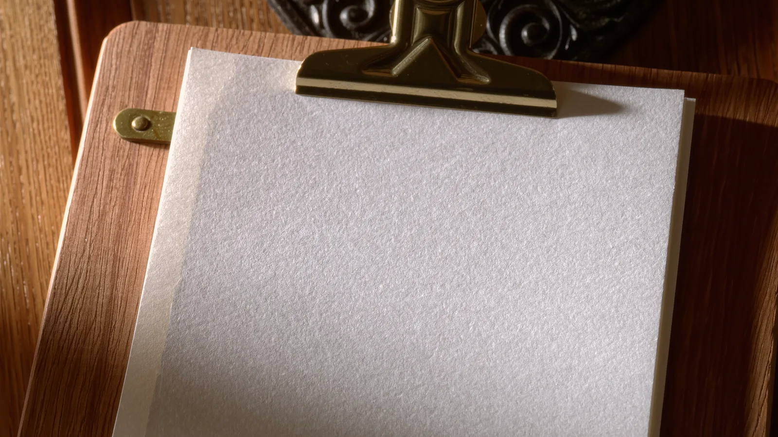 An ivory card in a brass menu holder