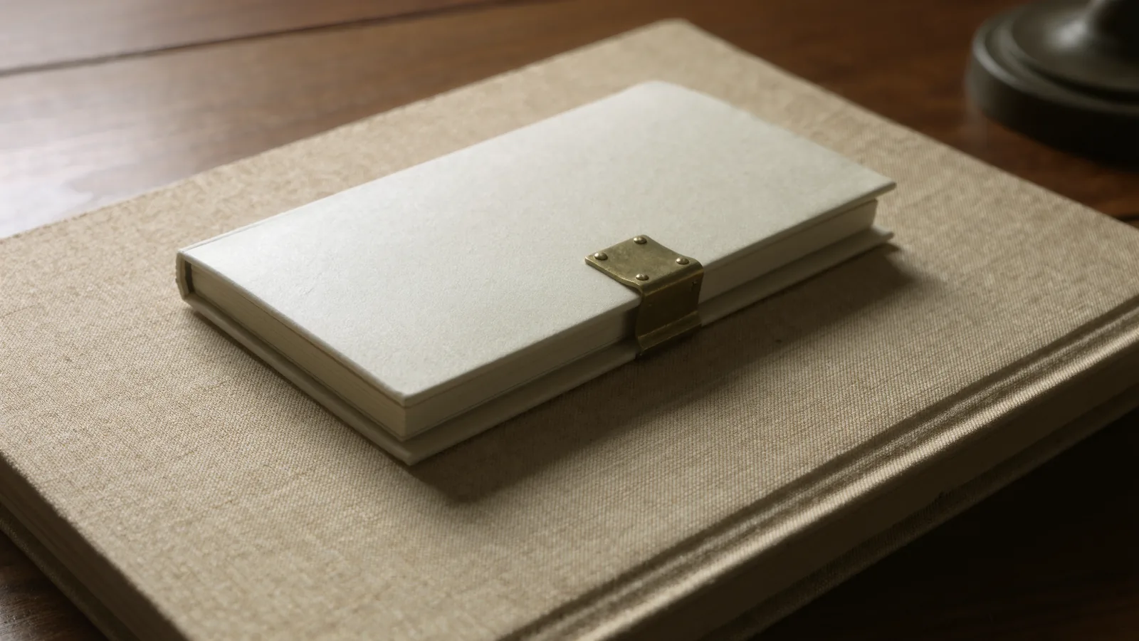 A slim bound volume beside a thick reference book, warm light